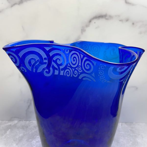Blenko-cobalt-blue-napkin-shaped-handblown-glass-vase-with-sandblasted-spiraling-out-of-control-design-close-up-view 