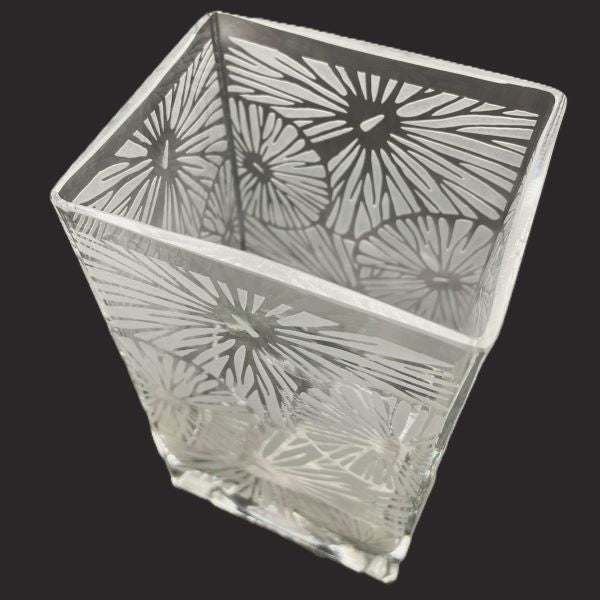 Clear blown glass vase with sandblasted floral design angled top view