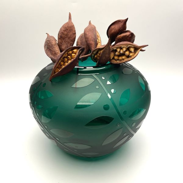 Green hand blown blass vase side view with sandblasted Leaf it to You design and seed pods