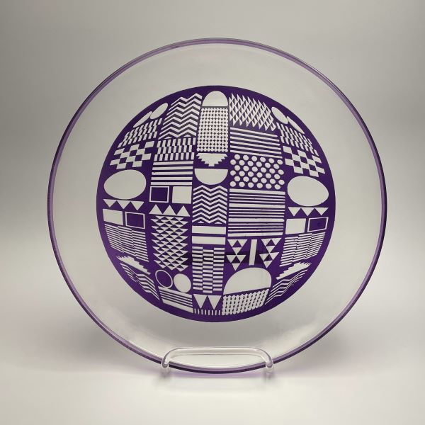 Painted-purple-plate-with-sandblasted-Geometrics-design-displayed-on-stand