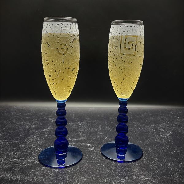 Blue Bubble Stem Champagne Glasses with Sandblasted Designs Black Background Champagne in Glass