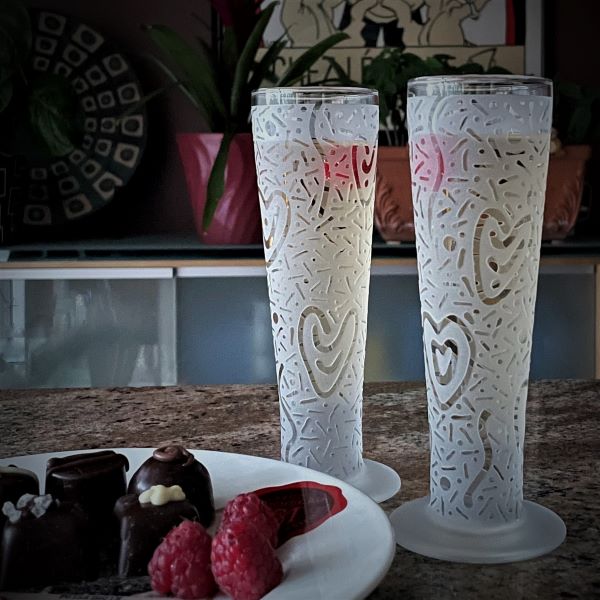 Champagne-flute-with-sandblasted-hearts-abound-design-champagne-raspberries-chocolates-side-view