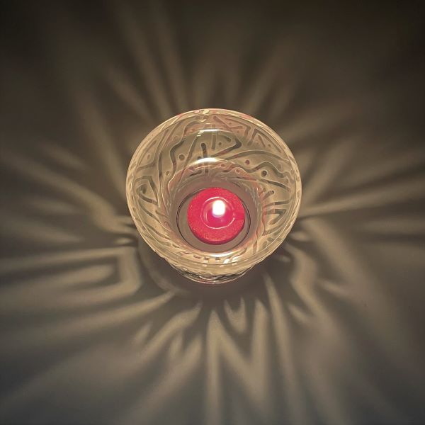 Clear-blown-glass-candle-holder-with-sandblasted-chama-design-top-view-with-candle