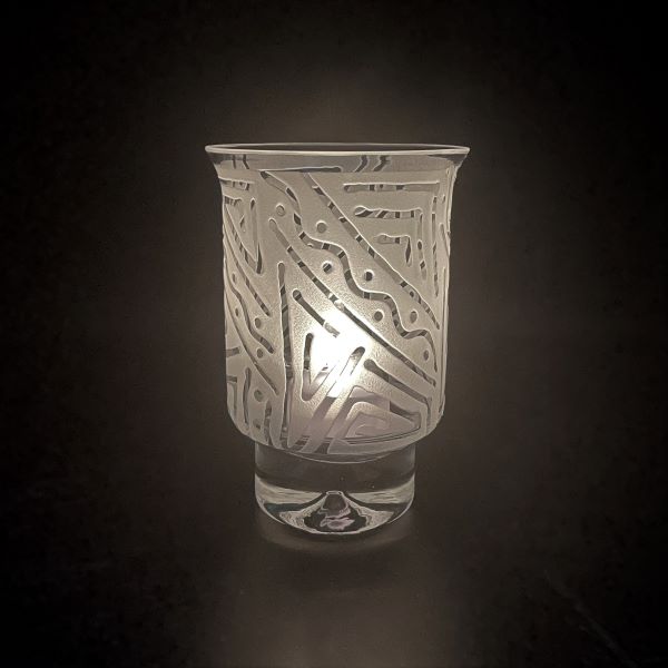 Clear-contempo-hand-blown-glass-candle-holder-with-Chama-design-side-view-with-candle