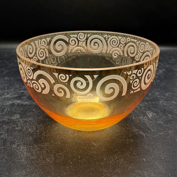 Irridescent-peach-bowl-with-spiraling-out-of-control-sandblasted-design-black-background