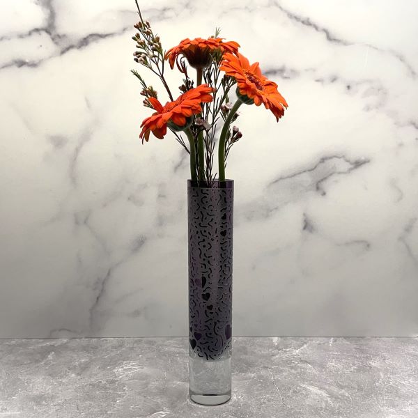 Purple-blown-glass-vase-with-sandblasted-hearts-abound-design-with-flowers