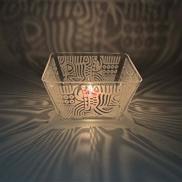 Square handblown glass bowl with sandblasted tribal abstract design with candle top view and shadow 