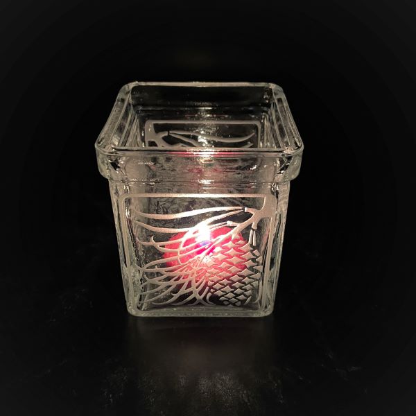 Square-Libbey-candle-holder-with-sandblasted-pinecone-design-with-lit-candle