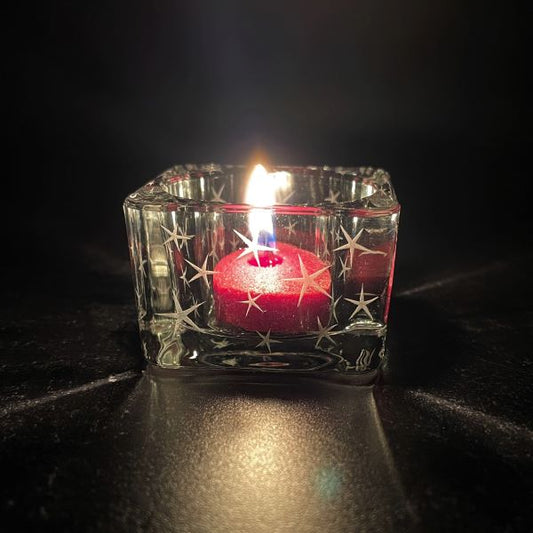 Square Glass Tealight Candle Holder with Sandblasted Star Design with lighted red candle 